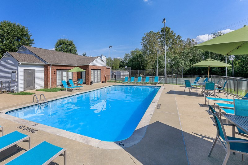 our apartments have a resort style pool with chairs and tables