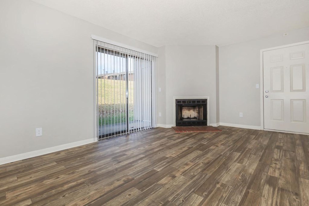 a living room with a fireplace and a sliding glass door