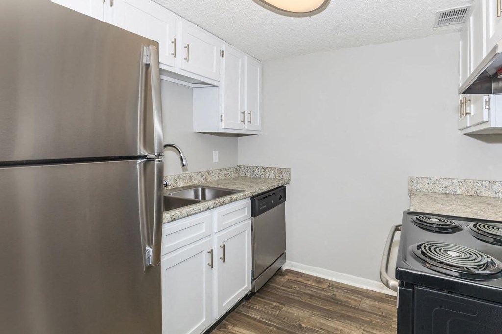 a kitchen with stainless steel appliances and white cabinets