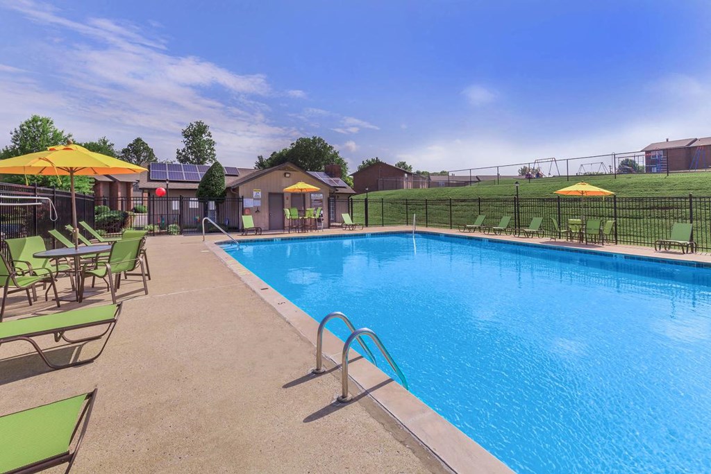 the swimming pool at our apartments has a resort style pool and lounge chairs