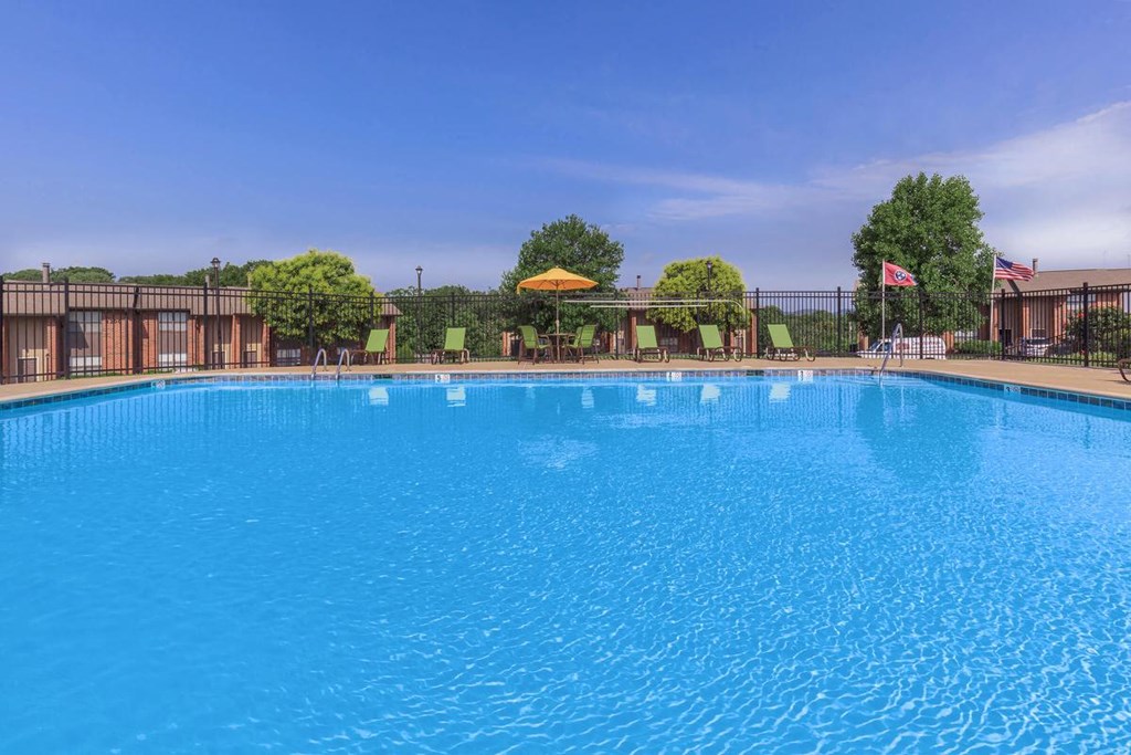 a large pool with a fence around it and a flag