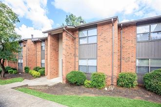 a brick building with a sidewalk in front of it