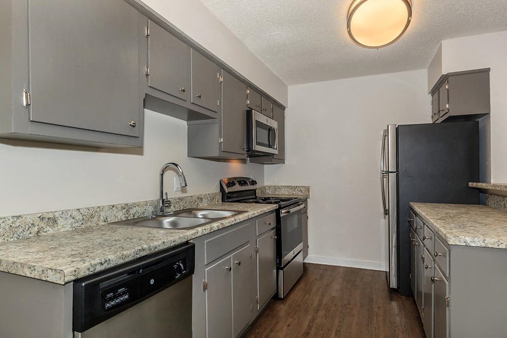 a kitchen with stainless steel appliances and granite counter tops