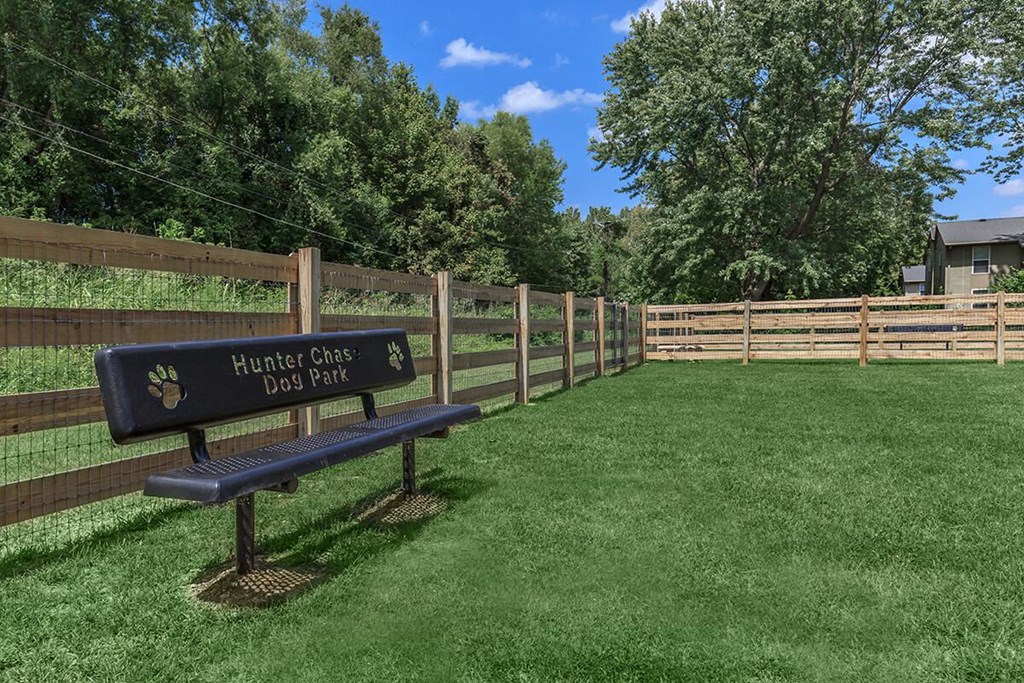 a park bench in a fenced in area with a fence