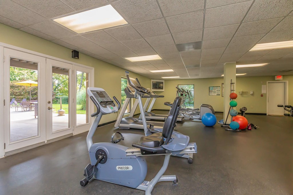 a gym with weights and other exercise equipment in a building