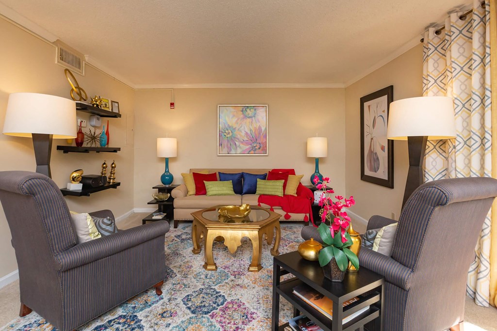 a living room with couches and chairs and a table