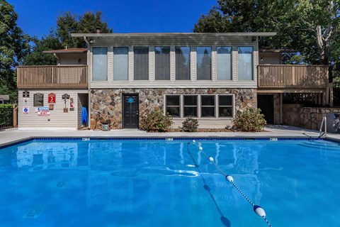 a house with a large blue pool in front of it