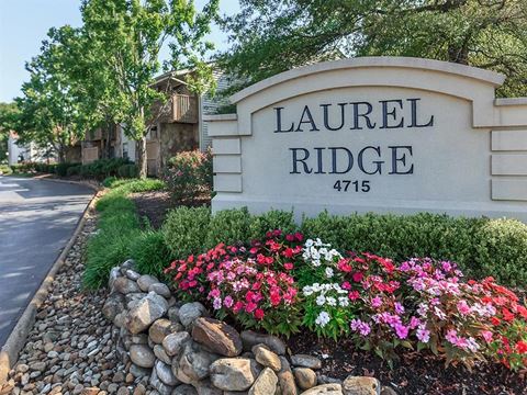 a sign for laurel ridge in front of a garden of flowers