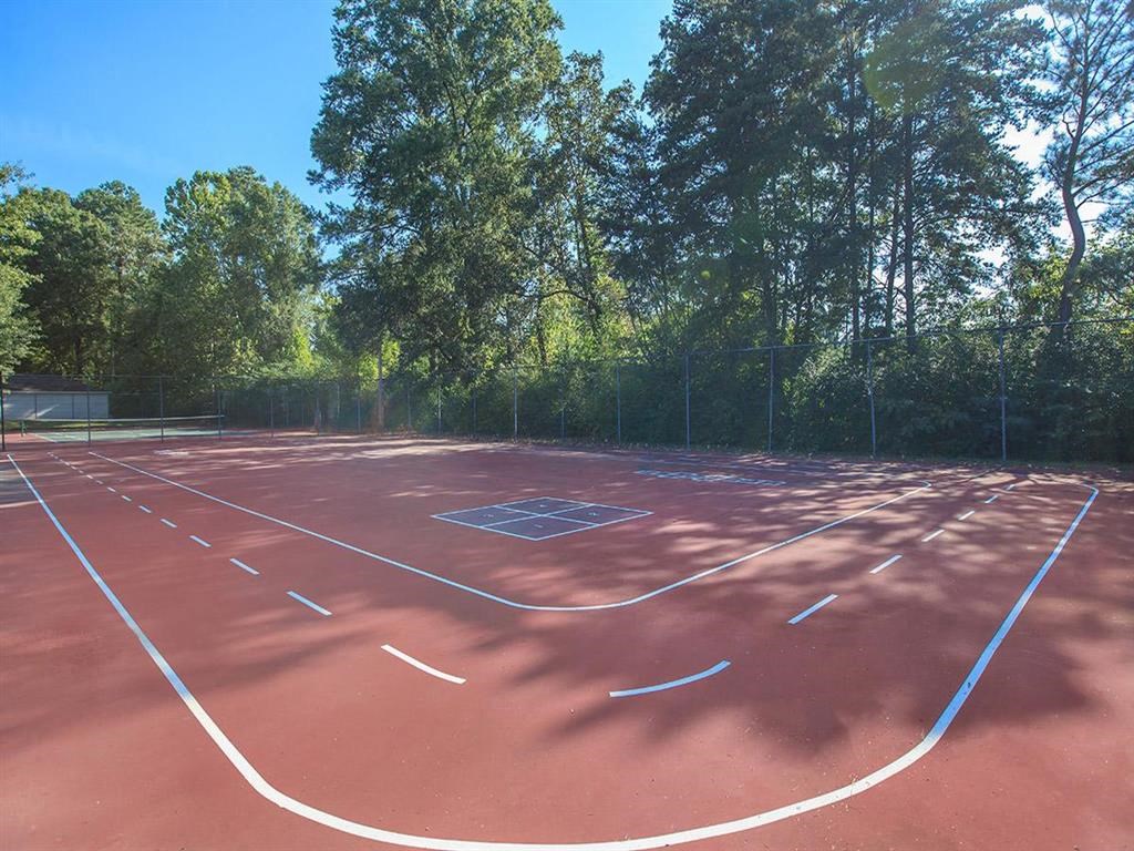 a red basketball court with white lines on it