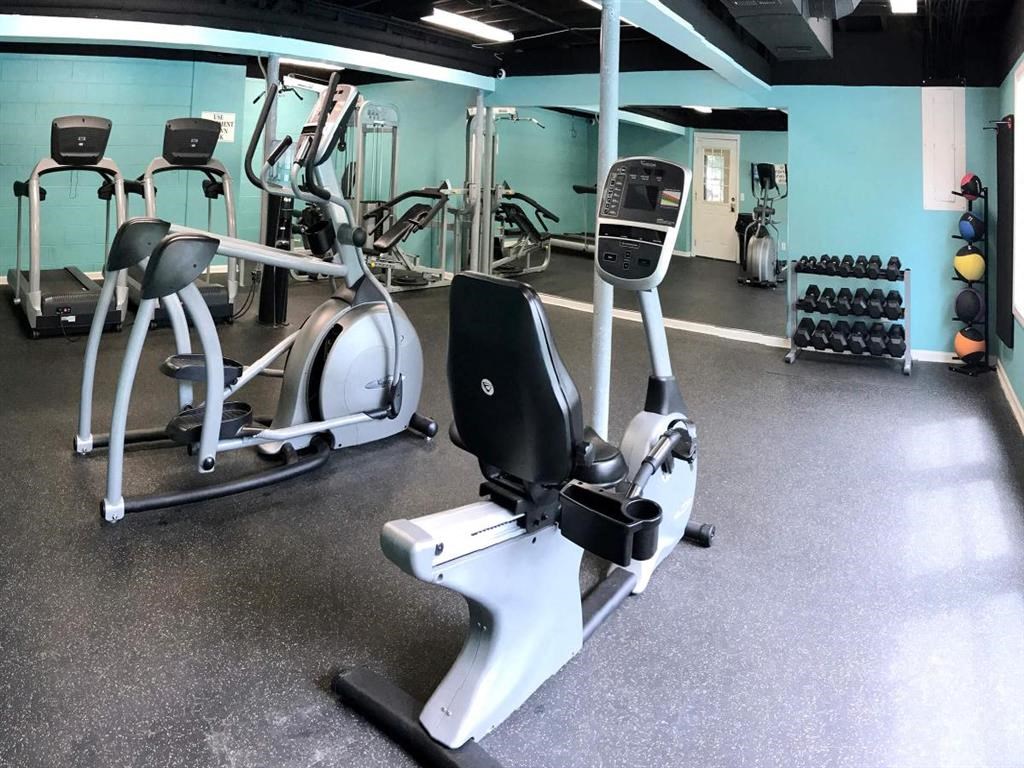 a gym with a lot of machines and weights