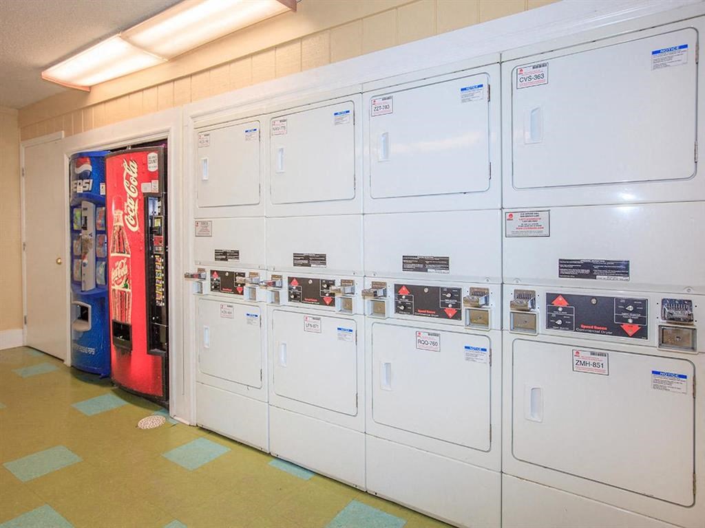 a row of white refrigerators in a room