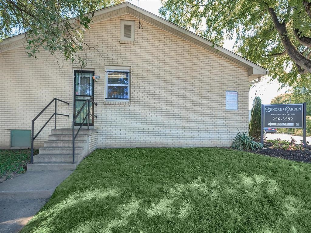 a white brick building with a sign in front of it