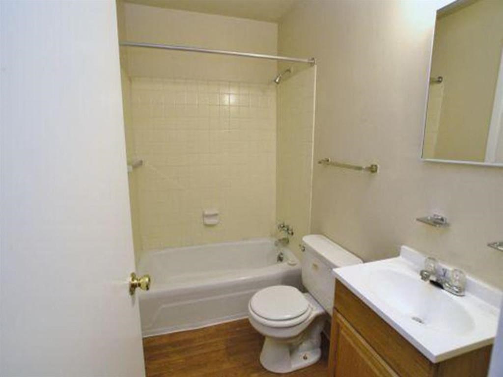 a white bathroom with a toilet and a sink
