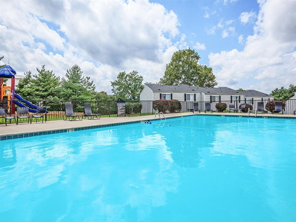 a large swimming pool with a building in the background