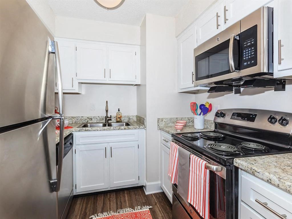 a kitchen with stainless steel appliances and white cabinets