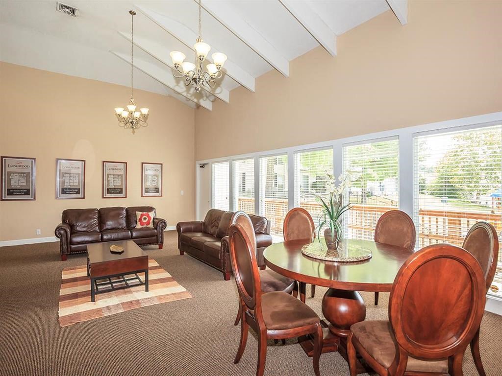 a living room with a table and chairs