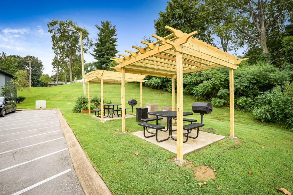 a patio with a picnic table and a pergola