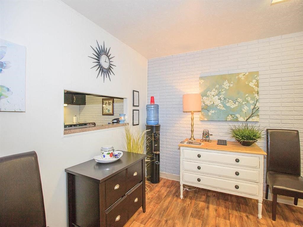 a living room with a dresser and a mirror