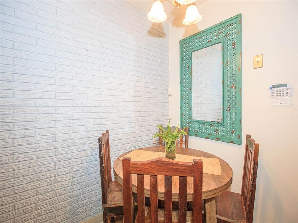 a dining room with a wooden table and a mirror