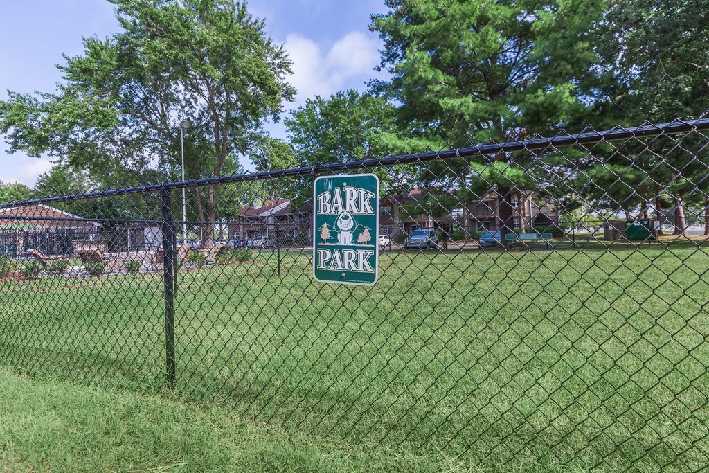 a gate park sign on the fence of a park