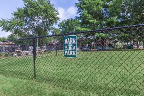 a gate park sign on the fence of a park