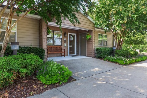front entrance to a home with a walkway and trees