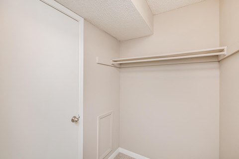 a bedroom with a white door and a white closet