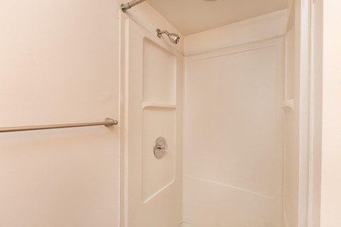 a white bathroom with a white door and a shower curtain