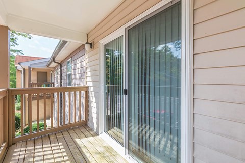the deck of a house with a sliding glass door