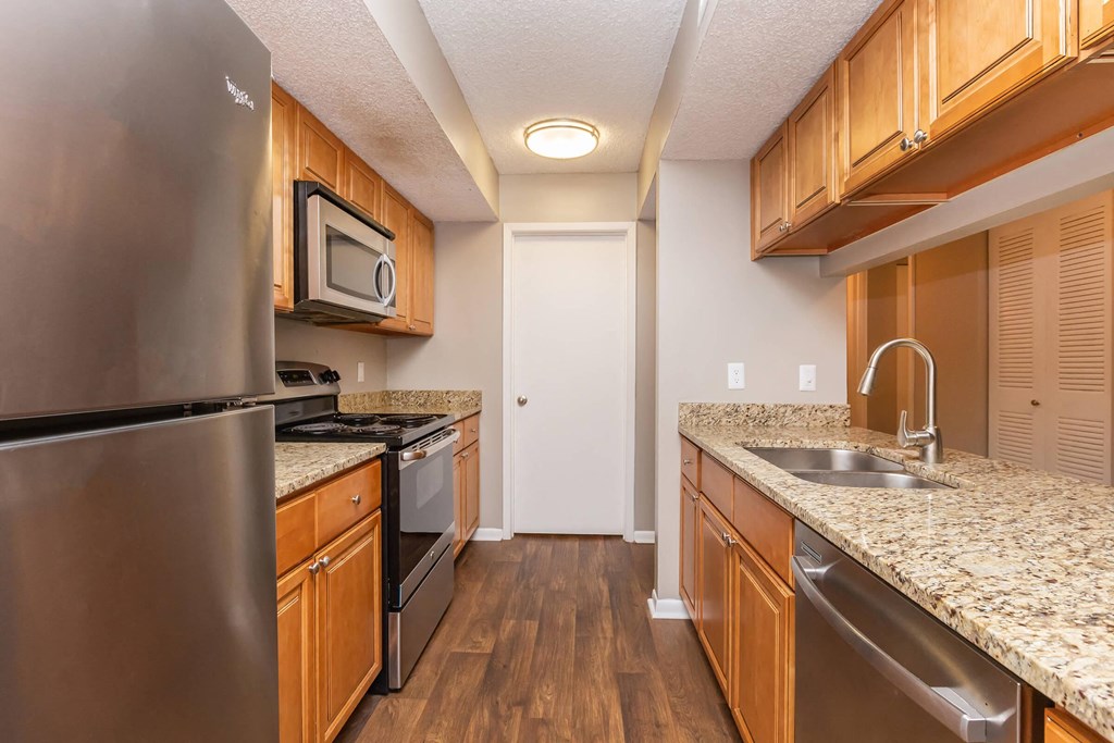 a kitchen with granite counter tops and stainless steel appliances