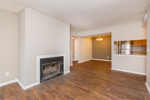 a living room with a fireplace and a wooden floor