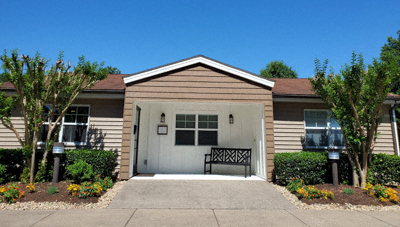 a small house with a bench in front of it