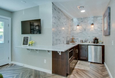 a kitchen with a white counter top and a sink