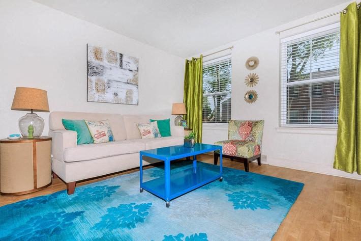 a living room with a couch and a blue coffee table
