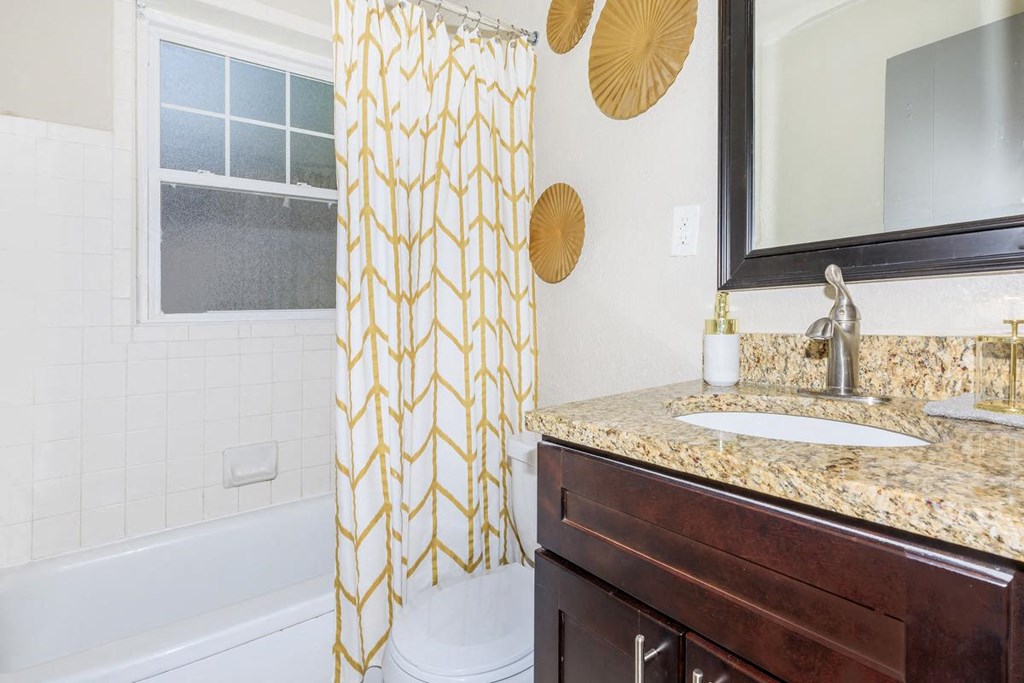 a bathroom with a shower curtain and a sink