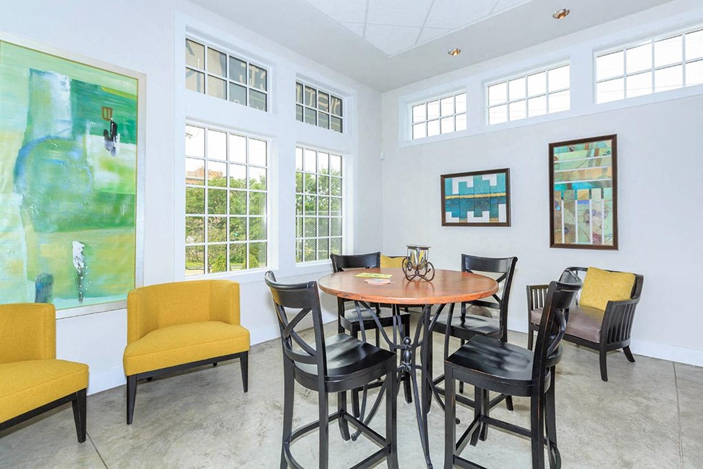 a dining room with a table and chairs and windows
