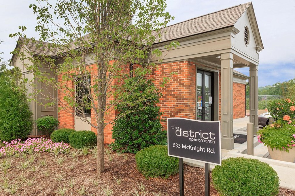 a sign in front of a brick building