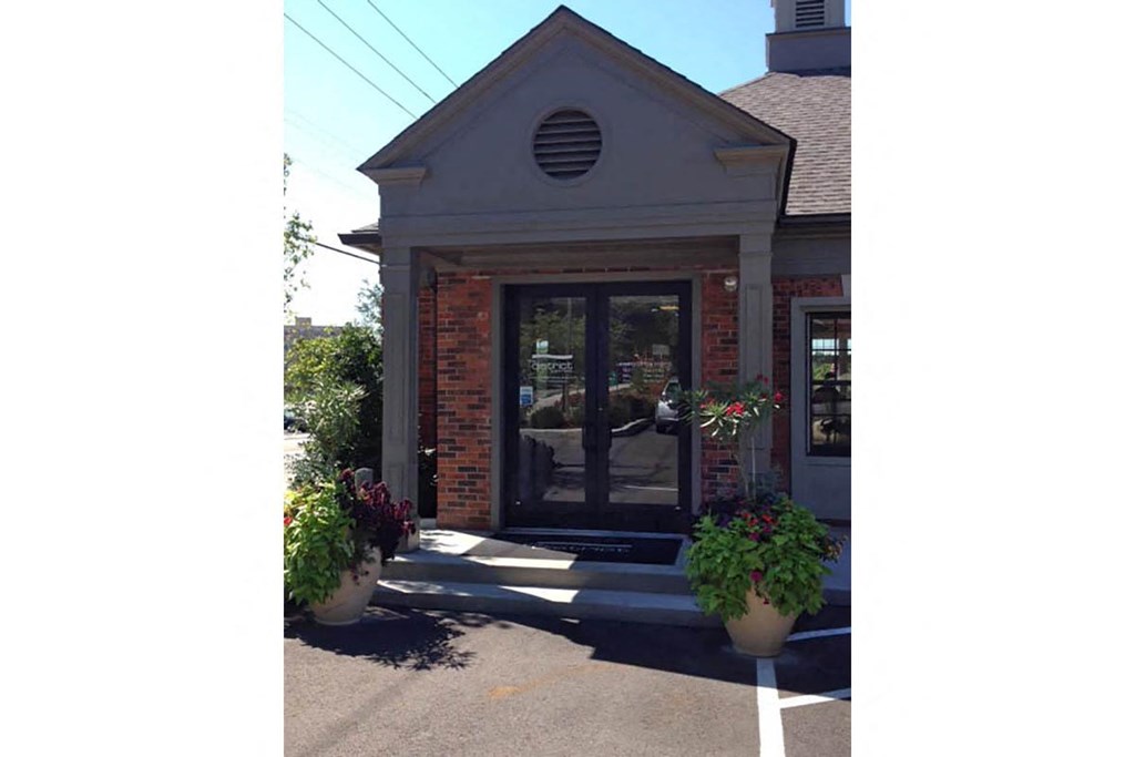 the front door is open and you can see the potted plants