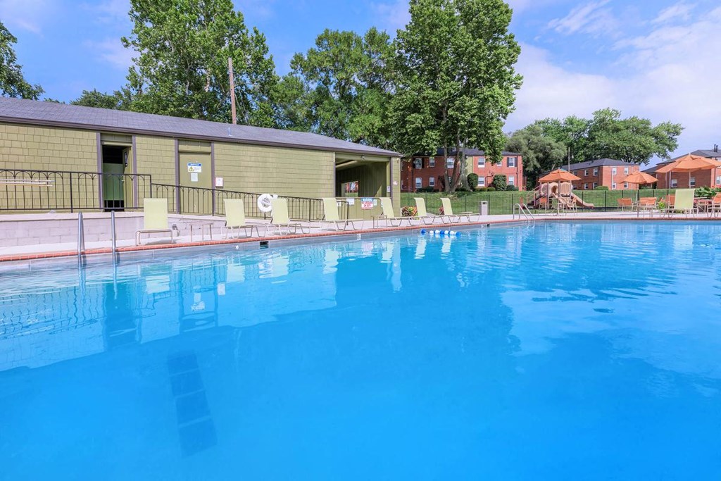 a large swimming pool with a building in the background