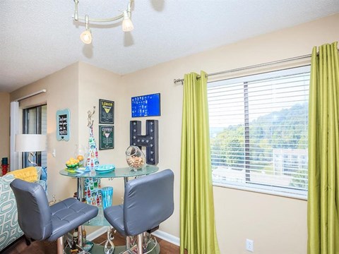 a dining room with a table and chairs and a window