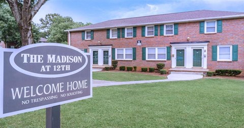 a house with a welcome sign in front of it