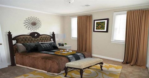 a bedroom with a bed and two windows