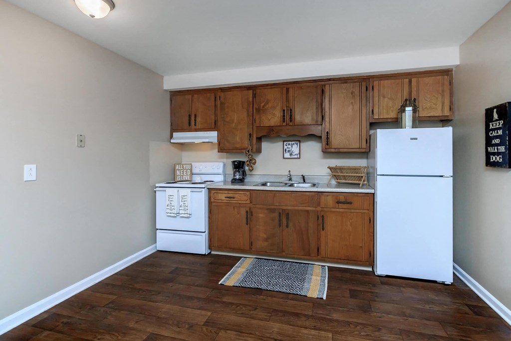 a kitchen with white appliances and wooden cabinets