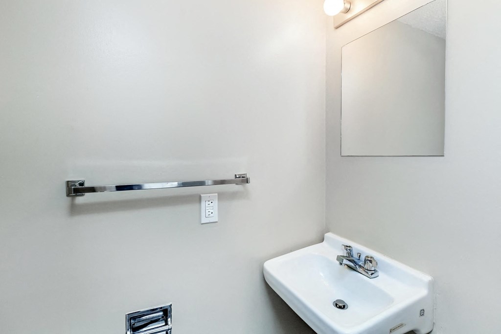a white bathroom with a sink and a mirror