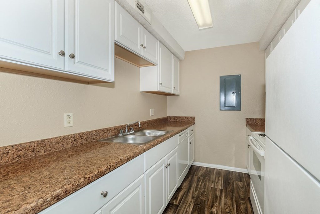 a kitchen with white cabinets and a counter top