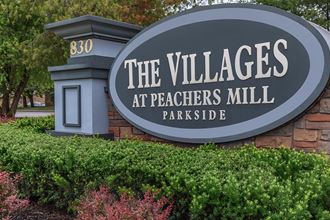 a sign for the villages at peaches mill parkide