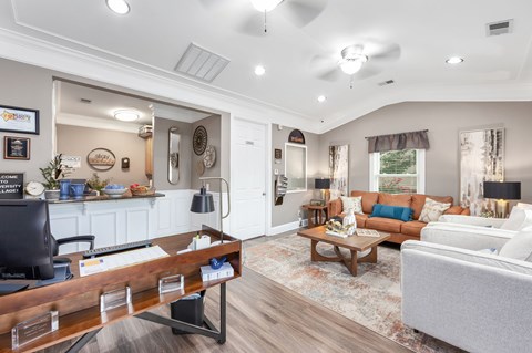 A well-lit living room with a white couch and a wooden coffee table.