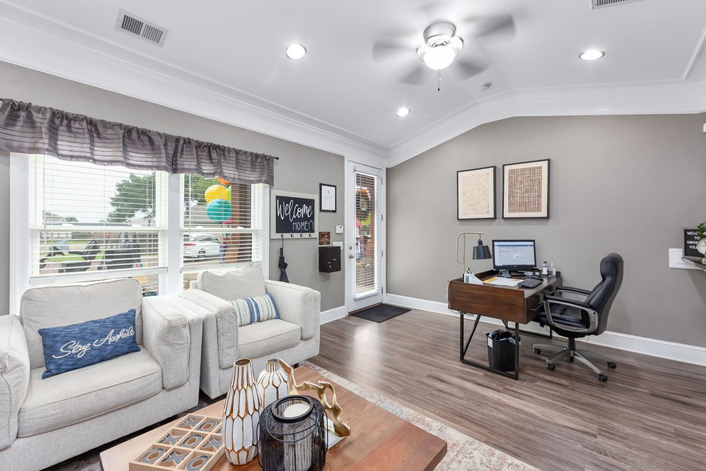 A living room with a white couch and a wooden coffee table.