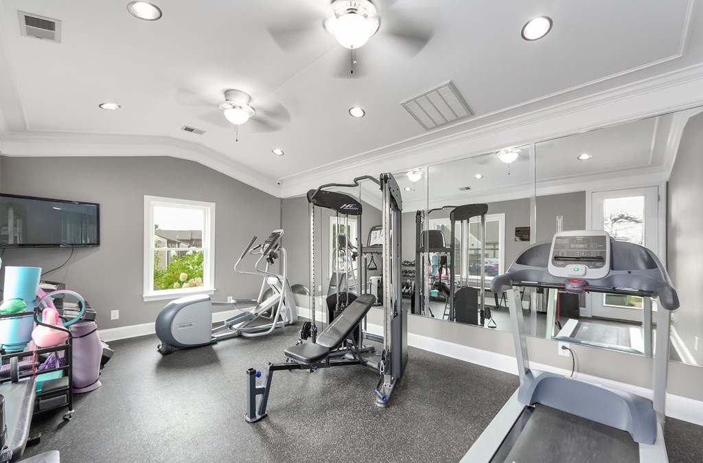 A spacious home gym with a variety of exercise equipment.