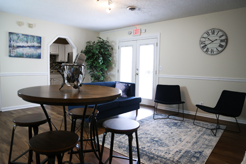 a living room with a couch and a table and chairs